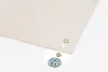 A close-up shot of a piece of beige fabric with grommets and tools for attaching them. Produktbild-Vorschau