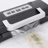 A close-up shot of a vacuum sealer machine with a bag of food being sealed. Podgląd zdjęcia produktu