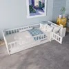 A child's bed with protective rails and bedding in a bedroom setting. Produktbild-Vorschau