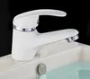 A white faucet with silver accents sits on the edge of a white sink filled with clear water. Produktbild-Vorschau