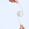Two hands holding a white retractable USB-C cable with a circular housing. Anteprima dell’immagine prodotto