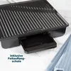 Close-up of a black grill with a drip tray extended. Produktbild-Vorschau
