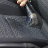 A hand is using a cleaning device to clean a car seat. Voir les images du produit