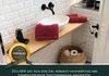 A bathroom sink area with towels and toilet paper. Produktbild-Vorschau