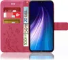 A pink flip case for a smartphone, showing credit cards and euro banknotes inserted into the case's compartments, with the smartphone screen displaying a colorful abstract image. Produktbild-Vorschau