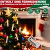 A decorated Christmas tree with lights and ornaments, in front of a fireplace, with a hand holding a remote control. Náhled obrázku produktu