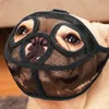A close-up of a dog's face wearing a black mesh muzzle. Produktbild-Vorschau