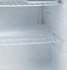 Interior of an empty refrigerator with white shelves. Voir les images du produit