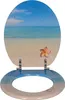 A toilet seat with a beach and ocean scene printed on it. Produktbild-Vorschau