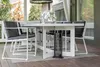 An outdoor patio dining set with chairs, a table, and a patio heater. Produktbild-Vorschau