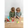 Two young children are playing with a colorful toy monster game on a wooden table. Podgląd zdjęcia produktu