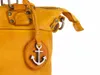 A close-up of a yellow leather handbag with an anchor charm. Produktbild-Vorschau