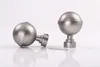 Two decorative finials for a curtain rod, one lying on its side and the other standing upright, with an Allen key in between them, all on a white background. Produktbild-Vorschau