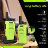 Two green walkie-talkies are shown, one in a charging dock, with text overlays detailing battery life and charging specifications. Produktbild-Vorschau
