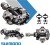A collage of Shimano GRX pedals and cleats for gravel and mountain bikes. Produktbild-Vorschau