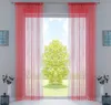 A room with a large window covered by red string curtains, with a tree visible outside. Produktbild-Vorschau