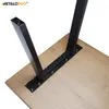 Close-up view of black metal table legs attached to a light brown wooden tabletop. Voir les images du produit