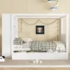 A child's bedroom with a white canopy bed, decorated with string lights and a monkey picture. Produktbild-Vorschau