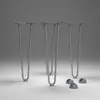 Four metal hairpin legs and four protective caps are arranged on a plain gray surface. Produktbild-Vorschau