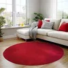 A red round rug in a living room setting with a sofa and plants.