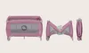 A collage of three images showing a pink travel crib in different states: fully assembled, partially folded, and fully folded. Anteprima dell’immagine prodotto