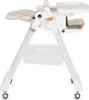 A side view of a white baby high chair with beige padding and rose gold accents. Náhled obrázku produktu