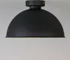 A black dome-shaped ceiling light fixture is shown against a light gray background. Anteprima dell’immagine prodotto