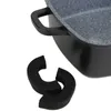 A close-up shot of a roasting pan with two silicone handle covers in the foreground. Produktbild-Vorschau
