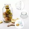 A clear studio shot of a large glass jar filled with apples, with additional close-up shots of jar details and lids. Podgląd zdjęcia produktu