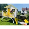 A child playing in a backyard with a playhouse and sandbox. Produktbild-Vorschau