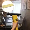 A hand holding a yellow window cleaning device with a microfiber pad, cleaning a wet window in an indoor setting. Produktbild-Vorschau