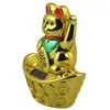 A golden lucky cat figurine sits on a pile of gold coins. Produktbild-Vorschau
