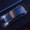 A blue remote control drift car with its headlights on, viewed from a top-down angle. Podgląd zdjęcia produktu