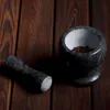 A granite mortar and pestle set on a wooden surface. Voir les images du produit