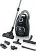 A black Bosch bag vacuum cleaner with its various attachments displayed around it. Produktbild-Vorschau