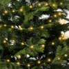 A close-up view of a decorated Christmas tree with green branches and warm white LED lights. Produktbild-Vorschau