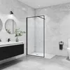 A modern bathroom with a walk-in shower, vanity, and toilet. Produktbild-Vorschau
