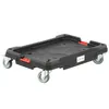 A black rolling platform with four wheels and red handles, shown against a white background. Náhled obrázku produktu