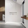 A modern bathroom with a walk-in shower, washing machine, and wooden accents. Voir les images du produit