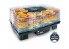 A fruit dehydrator filled with various sliced fruits and berries, displayed on a white background. Podgląd zdjęcia produktu