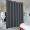 A dark gray outdoor curtain is used to divide a room, with a glimpse of a living area and a bedroom visible. Produktbild-Vorschau