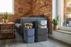 A living room scene with a sofa, brick wall, and storage bins. Produktbild-Vorschau