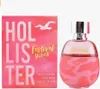 A bottle of Hollister Festival Vibes for Her Eau de Parfum and its packaging are displayed side-by-side against a white background. Anteprima dell’immagine prodotto