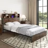 A bedroom scene featuring a bed with a headboard that includes storage and a charging station. Náhled obrázku produktu