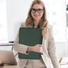 A woman in a business suit holds a laptop case in an office setting. Anteprima dell’immagine prodotto