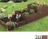 A tiered raised garden bed filled with various plants and flowers, set on a grassy lawn. Produktbild-Vorschau