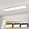 A white rectangular LED ceiling light panel is mounted on a white ceiling. Below the light, three smaller images show the light panel with different color temperatures: warm yellow, neutral white, and cool white. A white remote control is positioned to the Produktbild-Vorschau