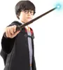 A young boy dressed as Harry Potter holds a wand with a glowing tip. Produktbild-Vorschau