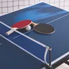 A mini table tennis set on a blue table tennis table with a net. Produktbild-Vorschau