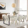 A dining room setting with a table and chairs, featuring a decorative lamp and artwork. Náhled obrázku produktu